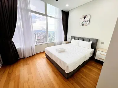 a bedroom with a bed and a large window at Skysuites Twin Tower Prime Location in Kuala Lumpur