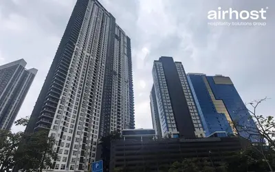 two tall skyscrapers in a city at MET 1 Residences Mont Kiara by Airhost in Kuala Lumpur