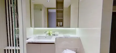 a bathroom with a sink and a mirror at SOHO Suites KLCC by noon in Kuala Lumpur