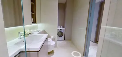 a bathroom with a sink and a washing machine at SOHO Suites KLCC by noon in Kuala Lumpur