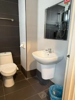 a bathroom with a toilet and a sink at Asto Hotel Kuala Lumpur in Kuala Lumpur