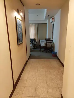 a hallway leading to a dining room with a table at kl Dreamx service suite at times square in Kuala Lumpur