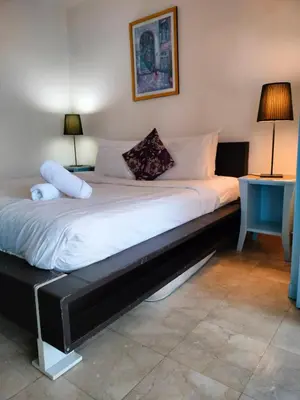 a large bed in a room with two lamps at kl Dreamx service suite at times square in Kuala Lumpur