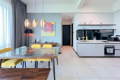 a dining room and kitchen with a table and chairs at Contemporary Apartment KL with 3 Bedrooms in Kuala Lumpur