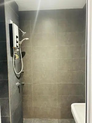 a bathroom with a shower and a sink at Cozy unit By Rasbo Galaxy with LRT , Pool , KLCC in Kuala Lumpur