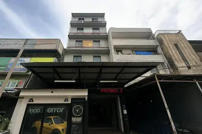 a yellow car is parked in front of a building at 98 Inn BilikXpert at Chow Kit in Kuala Lumpur