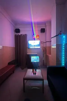 a room with a table and a tv with a purple light at 98 Inn BilikXpert at Chow Kit in Kuala Lumpur