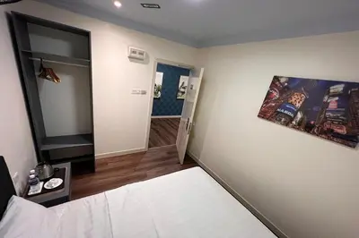 a small room with a bed and a mirror at Hotel AL Amin in Kuala Lumpur