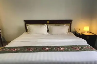 a bedroom with a bed with two pillows at Hotel AL Amin in Kuala Lumpur