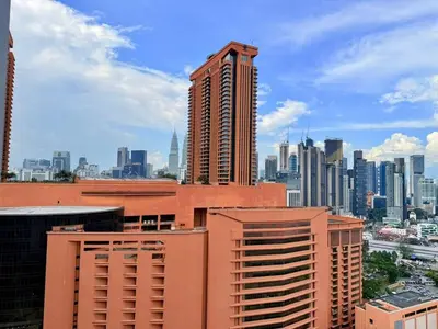 a view of a city skyline with tall buildings at Taragon Puteri Bintang KLCC View Studio Apartment in Kuala Lumpur