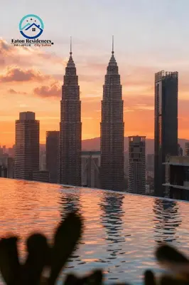 a view of a city skyline from a swimming pool at Eaton Residence City Suites in Kuala Lumpur