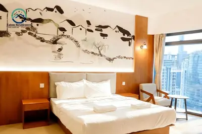 a hotel room with a bed and a window at Eaton Residence City Suites in Kuala Lumpur