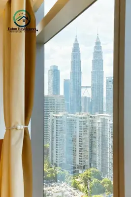 a view of the kuala lumpur city skyline from a window at Eaton Residence City Suites in Kuala Lumpur