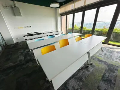 a classroom with white desks and orange chairs at KL Sentral Monorail 4 pax Kuala Lumpur, Sky Pool Family Merdeka 118 Nice View in Kuala Lumpur