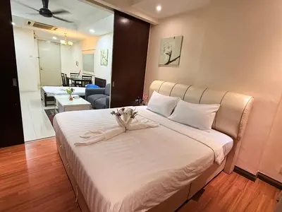a bedroom with a large white bed with flowers on it at Taragon Putri Bintang in Kuala Lumpur