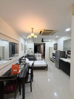 a living room with a couch and a dining room at Taragon Putri Bintang in Kuala Lumpur