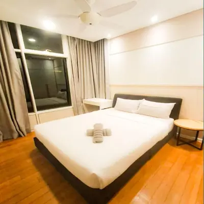a large white bed in a room with a window at Kuala Lumpur Sky Suites KLCC in Kuala Lumpur