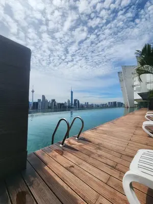 a wooden deck with a view of the city at Infinity Pool Hostel KL in Kuala Lumpur