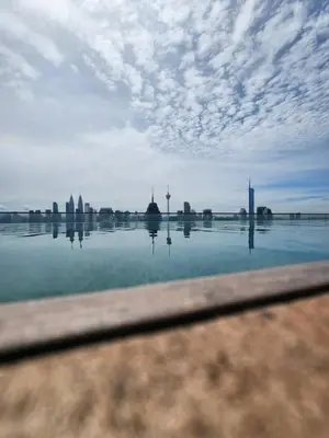 a large body of water with a city in the background at Infinity Pool Hostel KL in Kuala Lumpur