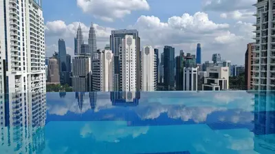 a view of a city skyline from a swimming pool at Majestic Residence Suites KLCC by Homebrickz in Kuala Lumpur