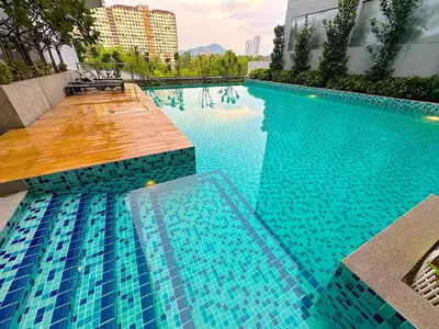 a swimming pool with blue water in a building at Neu Suites by Serenity Luxe Suites in Kuala Lumpur