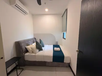 a small bedroom with a bed in a room at Neu Suites by Serenity Luxe Suites in Kuala Lumpur