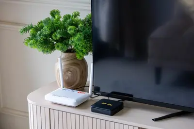 a table with a tv and a plant and a keyboard at SV001 Maluri - Sunway Velocity - Cheras Stay in Kuala Lumpur