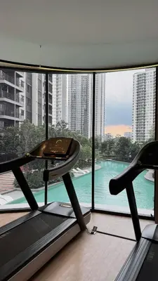 a room with a treadmill and a large window at M Arisa Sentul City View Condo in Kuala Lumpur