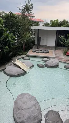 a backyard with rocks and a swimming pool at M Arisa Sentul City View Condo in Kuala Lumpur