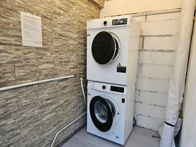 a washer and dryer sitting next to a brick wall at VG Homes in Kuala Lumpur
