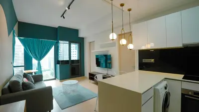 a kitchen and living room with a couch and a table at Star KLCC Comfort Suite 3-4pax in Kuala Lumpur