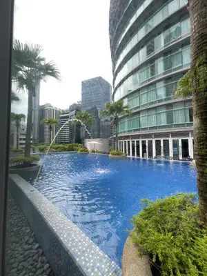 a large swimming pool in front of a building at Vortex Suites KLCC By GuestHouse in Kuala Lumpur