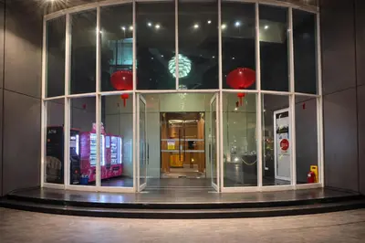 a building with a large glass window with red decorations at Vortex Suites KLCC By GuestHouse in Kuala Lumpur