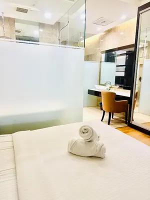 a towel sitting on a bed in a room at Dorsett Serviced Suites Kuala Lumpur By NP in Kuala Lumpur