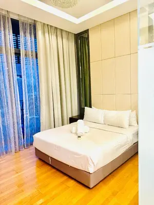 a bedroom with a bed with white sheets at Dorsett Serviced Suites Kuala Lumpur By NP in Kuala Lumpur