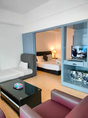 a living room with a bed and a large mirror at Glacier suite at times square kl in Kuala Lumpur