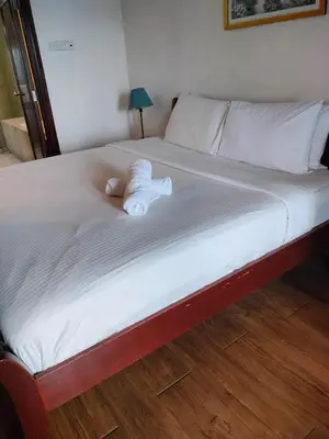 a bed with a stuffed animal laying on it at Glacier suite at times square kl in Kuala Lumpur