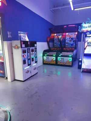 a room with two arcade games and a machine at KL Heart Suite at berjaya Times Square in Kuala Lumpur