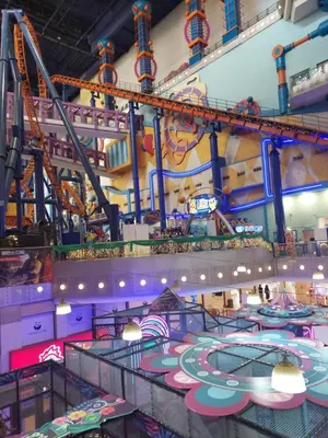 a large indoor amusement park with a roller coaster at KL Heart Suite at berjaya Times Square in Kuala Lumpur