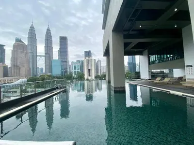 a swimming pool with a view of a city skyline at Cozy Stay at Legasi 5 min Walking distance to KLCC 2 in Kuala Lumpur