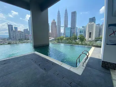a swimming pool with a view of a city skyline at Cozy Stay at Legasi 5 min Walking distance to KLCC 2 in Kuala Lumpur