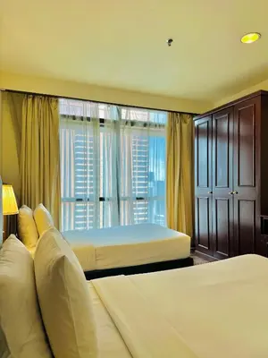 a hotel room with two beds and a window at City view Service Residence At Times Square kL in Kuala Lumpur