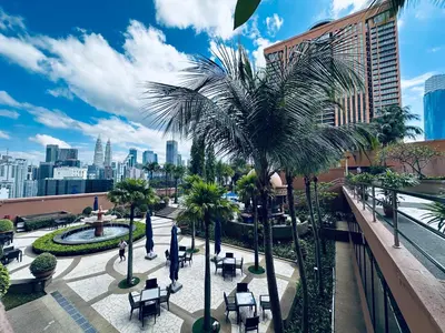 a view of a city with a palm tree at City view Service Residence At Times Square kL in Kuala Lumpur