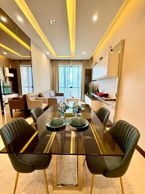a living room with a dining table and chairs at Dorsett Luxury KLCC by IHG in Kuala Lumpur