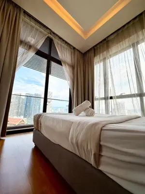 a bedroom with a large bed and a large window at Dorsett Luxury KLCC by IHG in Kuala Lumpur