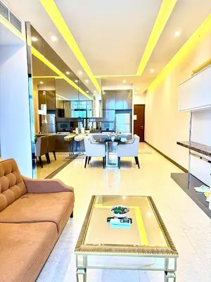 a living room with a couch and a table at Dorsett Luxury KLCC by IHG in Kuala Lumpur