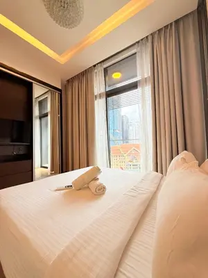 a bedroom with a white bed with a window at Dorsett Luxury KLCC by IHG in Kuala Lumpur