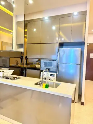a kitchen with a sink and a refrigerator at Dorsett Luxury KLCC by IHG in Kuala Lumpur