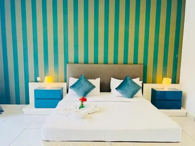 a bedroom with a bed with blue and green walls at The Platinum KLCC By Elegant Suites in Kuala Lumpur