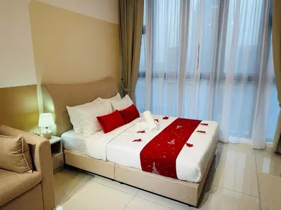 a bedroom with a bed with red pillows at Majestic Residence Kuala Lumpur City Centre in Kuala Lumpur